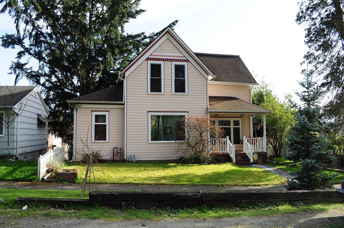 Calm South Sound residential house with porch and evergreen trees